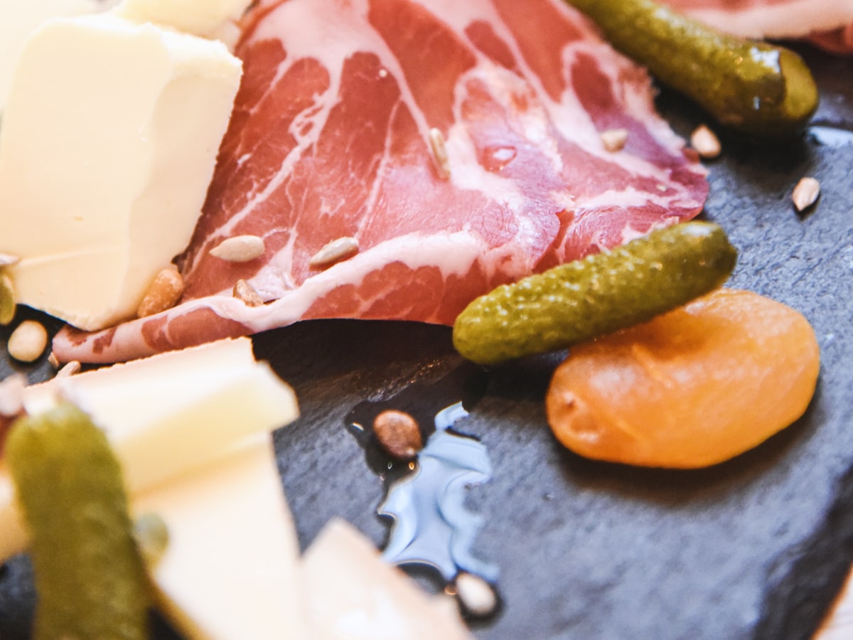 Charcuterie gift basket with board, salami, and crackers