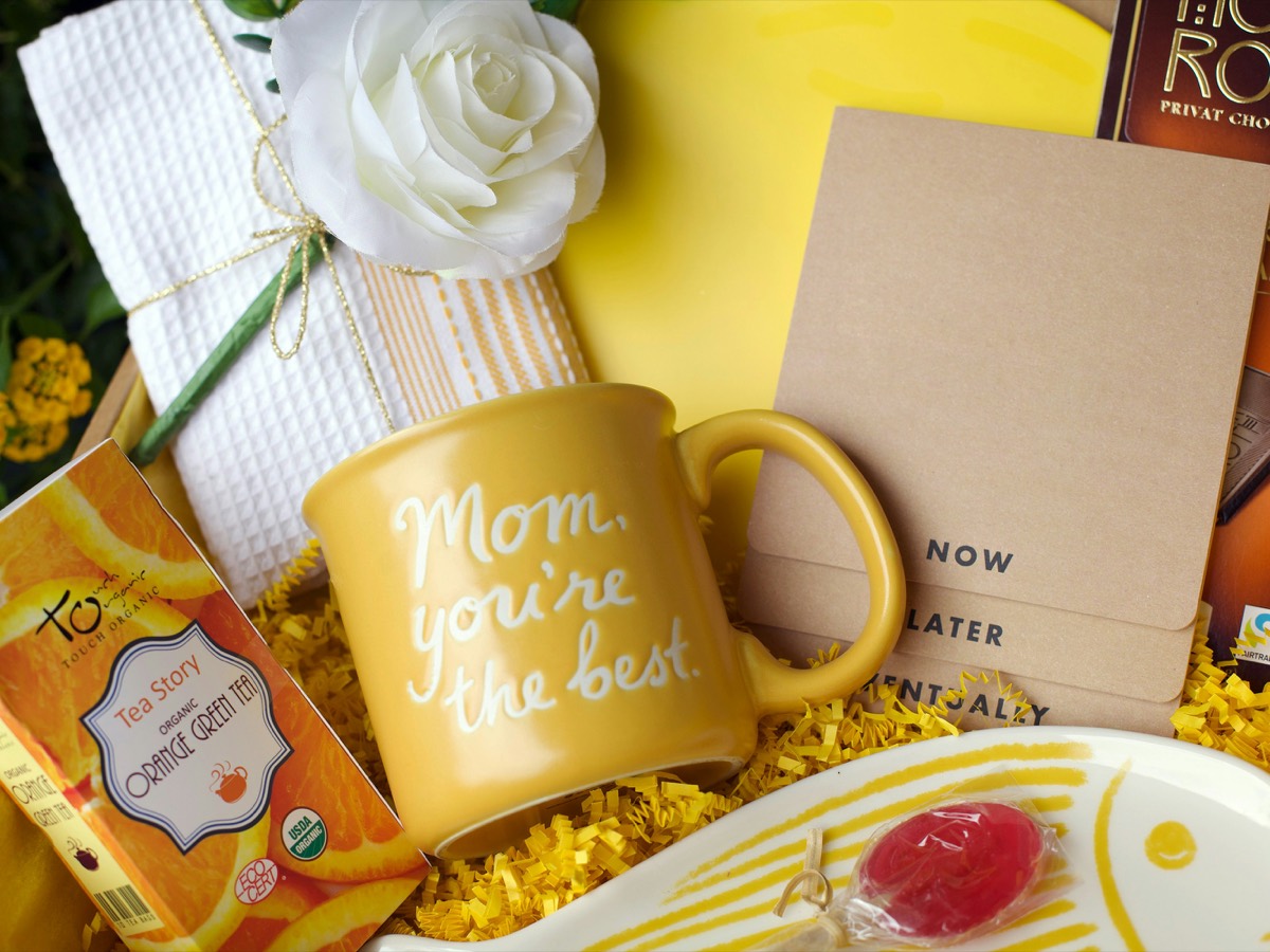 Thank You gift box with a mug, tea, chocolate, and a fresh white rose